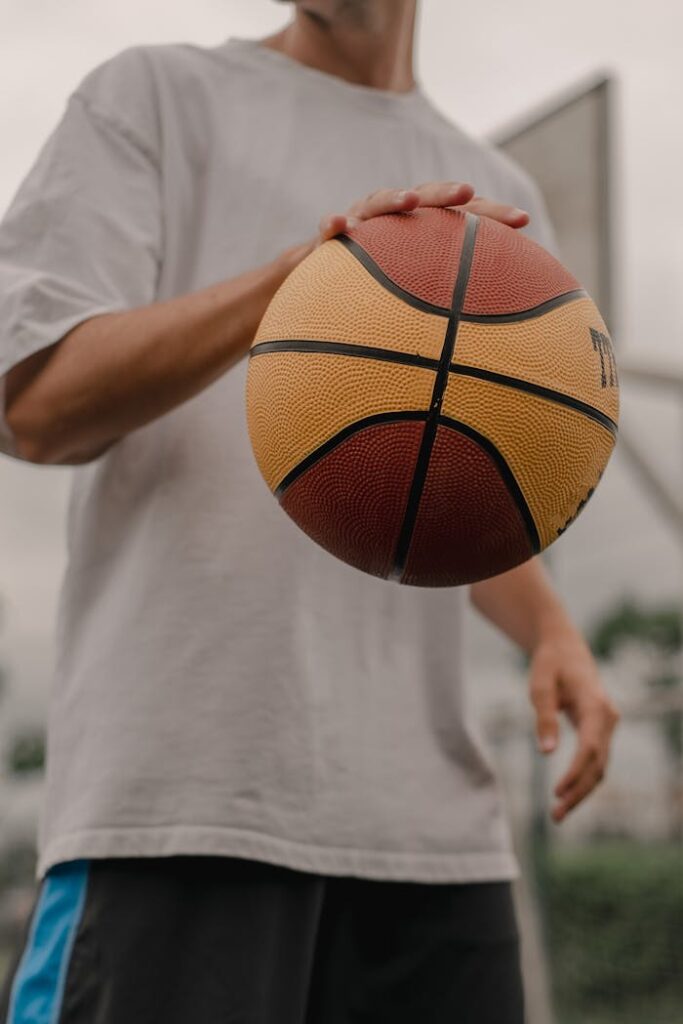 a-man-in-white-crew-neck-t-shirt-dribbling-a-basketball-8084787 A Man in White Crew Neck T-shirt Dribbling a Basketball