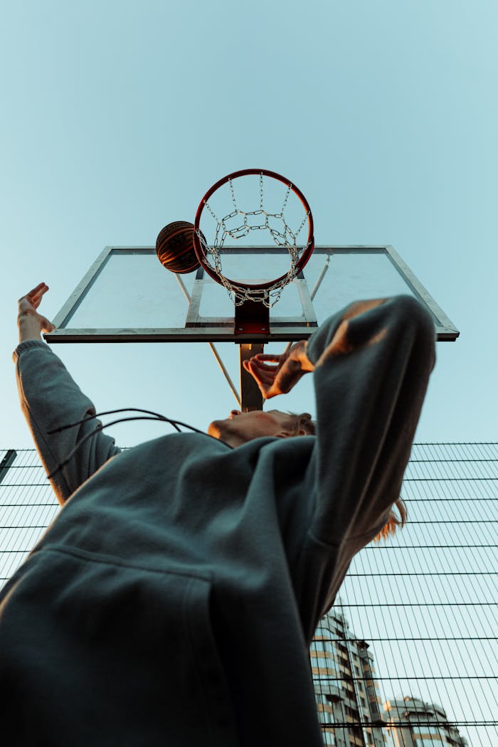 Person in Hoodie Playing Basketball